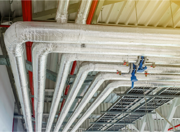 Open ceiling of a commercial building showing a large piece of ductwork