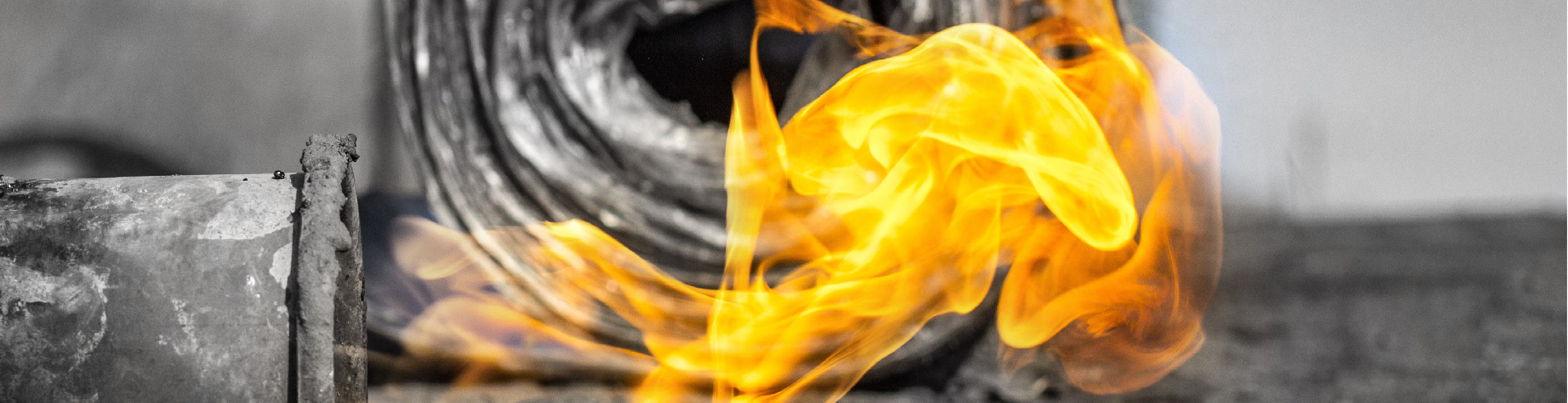 Hero image of a translucent yellow flame in front of a roll of metal cladding