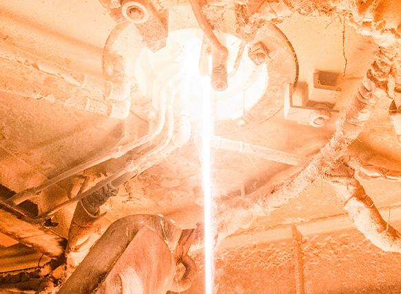 Photo of a large trunk pipe with multiple heavilly insulated joints extending from it.