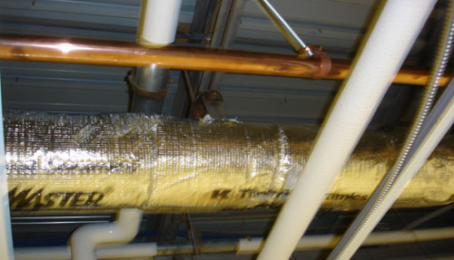 Photo of return plenum containing insulated pipe